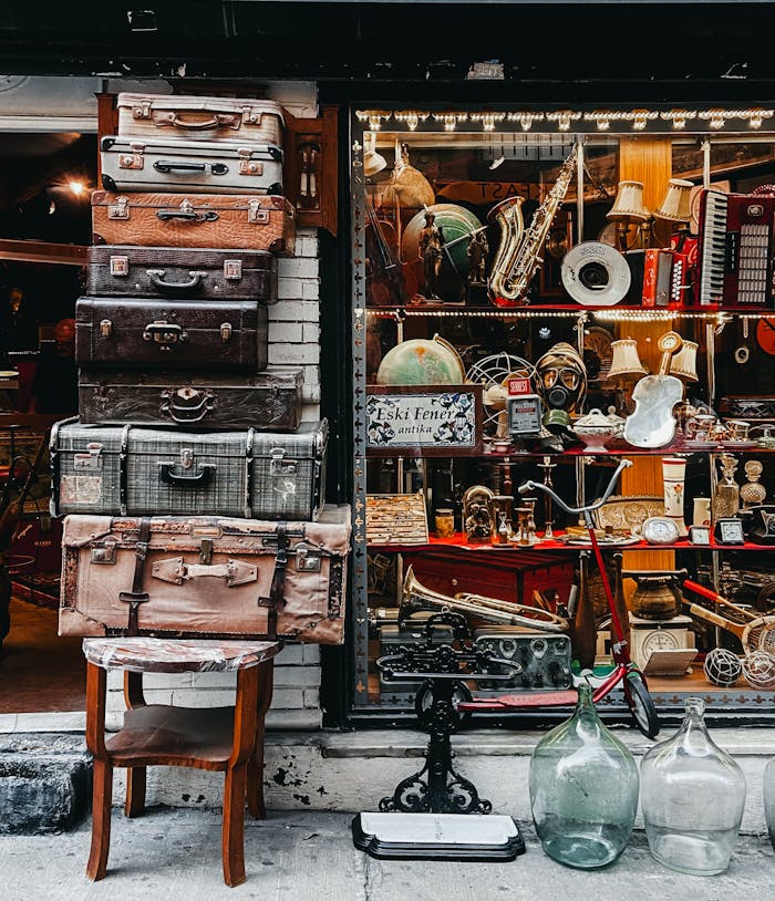 A collection of vintage suitcases and retro items displayed at an antique store.